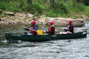 3 person canoe in the rapids