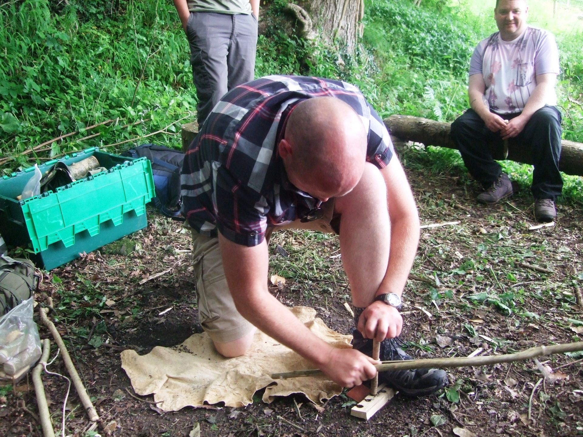 Learning how to use bow drill in a bushcraft session.