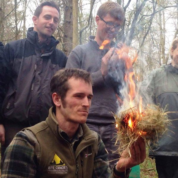 A Wye Adventures instructor demonstrating fire by friction.