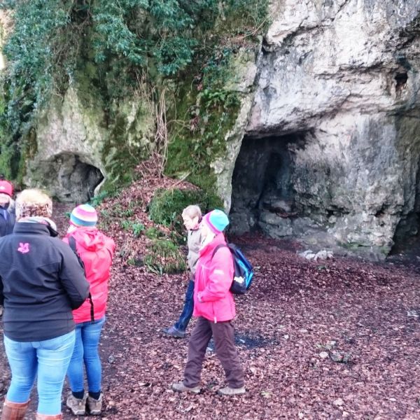 Exploring King Arthurs cave on a guided walk.
